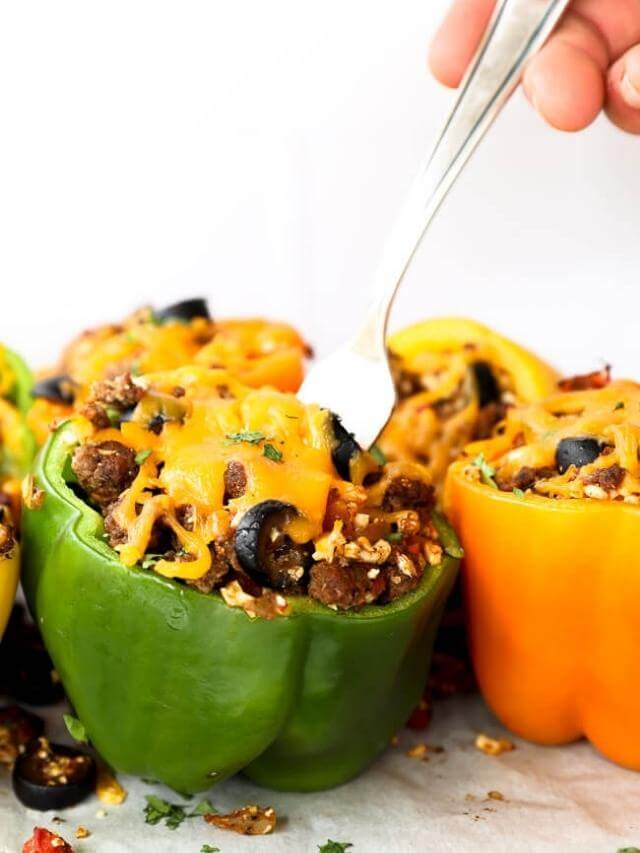 Stuffed bell peppers with beef and cheese and fork digging into a bite