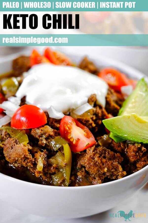 Keto chili a bowl topped with chopped onion, tomatoes, avocado and coconut yogurt. Long pin for pinterest. 
