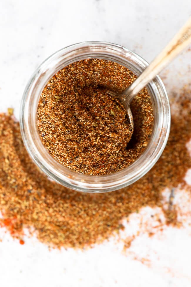 Keto taco seasoning in a jar with a spoon close up overhead image
