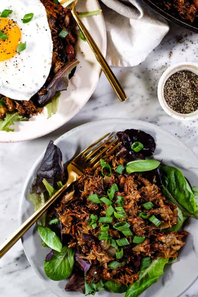 Leftover pulled pork hash on plates with green onion topping