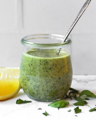 Lemon herb sauce in a jar with spoon sticking out