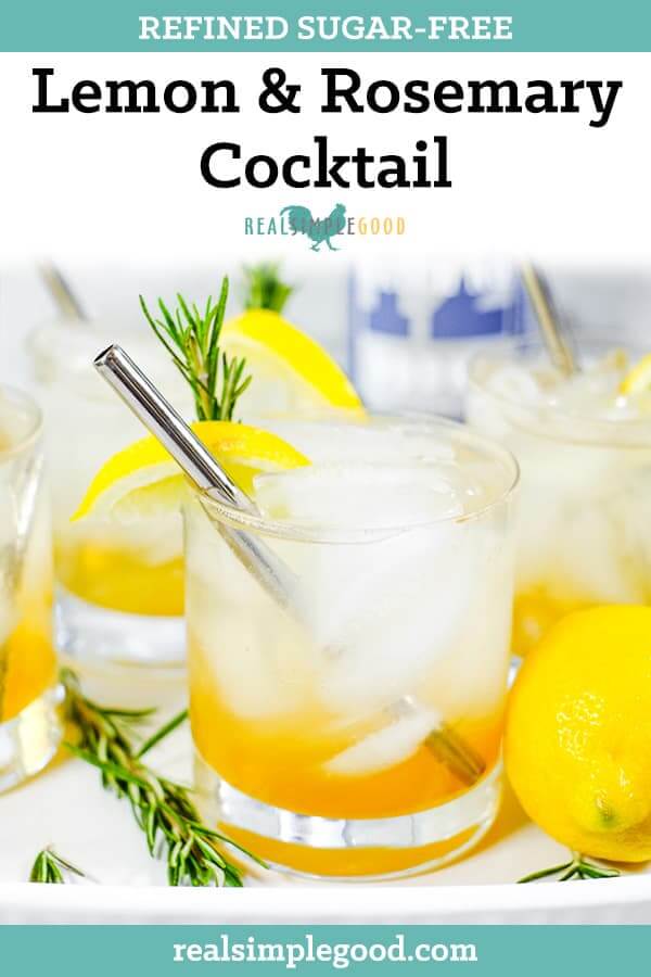 Tray with four glasses of iced lemon & rosemary cocktail with lemon wedges, fresh rosemary and stainless steel straws long pin. 