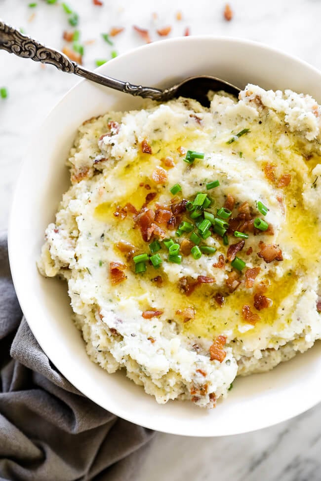 Loaded mashed cauliflower with butter and bacon on top in a bowl