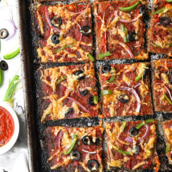 Meatza (or meatzza) pizza on a sheet pan cut into squares (overhead image)