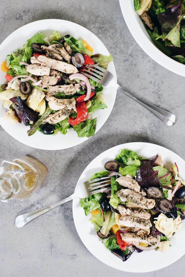 The flavors of this Paleo + Whole30 mediterranean chicken salad take it a notch above the typical salad. It's fresh, flavorful and so easy to make! Filled with fresh lettuce, chicken, olives, roasted peppers, artichoke hearts, red onion and homemade dressing. Paleo + Whole30. | realsimplegood.com