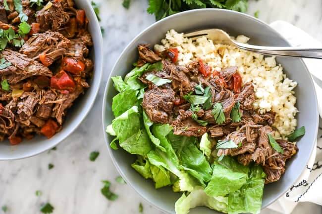 Mexican shredded beef in bowl with cauliflower rice and chopped lettuce horizontal photo