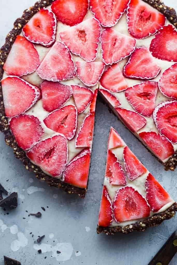 No bake chocolate tart with strawberries on top slice taken out