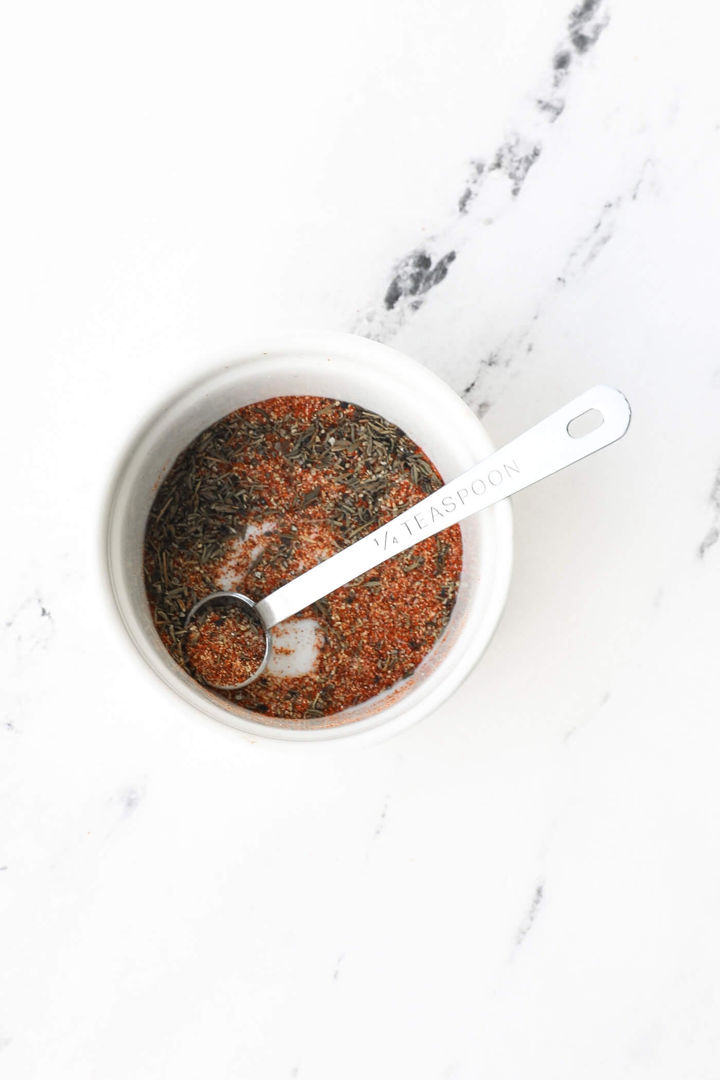Seasonings for air fryer shrimp in a ramekin with a measuring spoon.