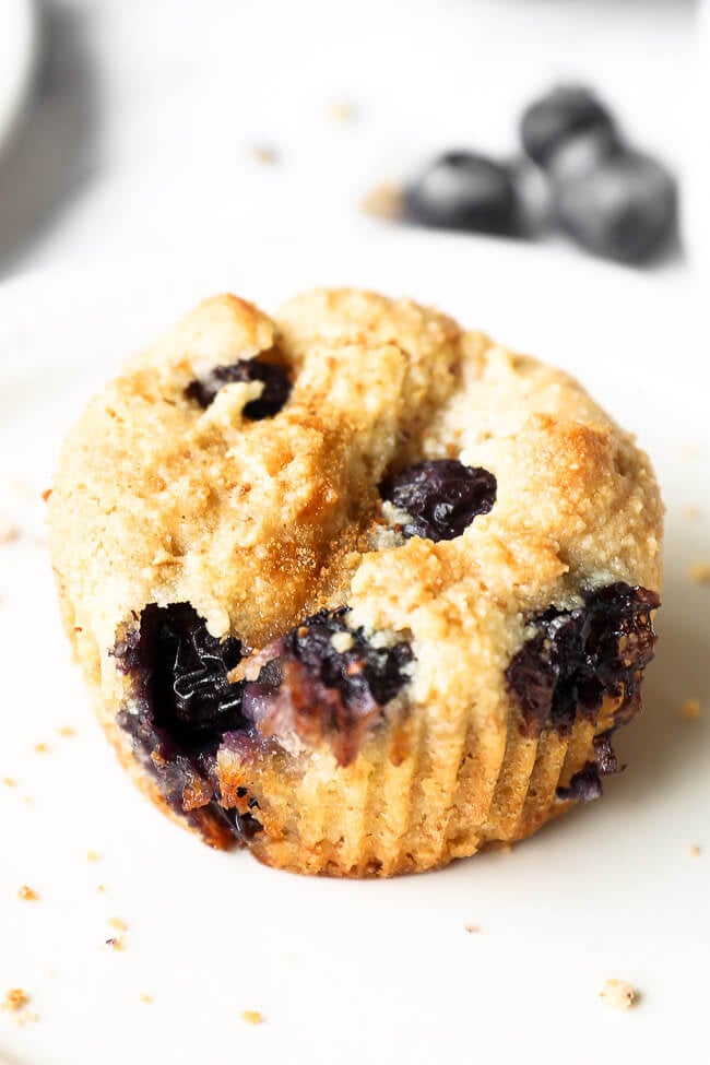 Close up angled image of one vegan blueberry muffin. 