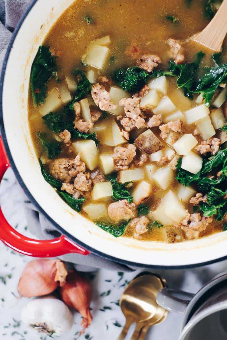Curling up with a big bowl of this Paleo sausage soup feels so comforting and soul-satisfying. It's filled with roasted garlic, potatoes and kale. Paleo, Whole30 and Dairy-Free. | realsimplegood.com