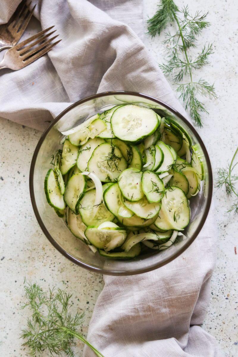 cucumber dill salad in a glass bowl - overhead shot