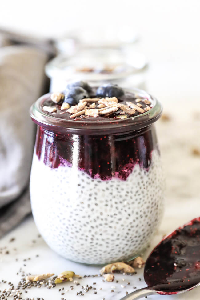 Paleo chia seed pudding straight on shot of jars in line with blueberry at top