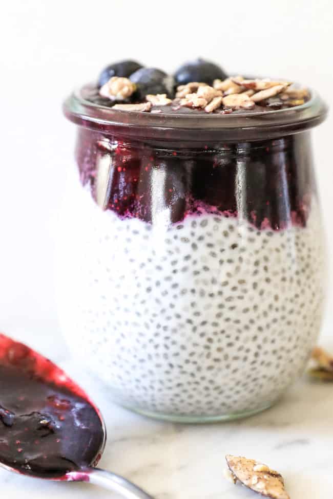 Paleo chia seed pudding straight on shot of single jar with blueberry at top