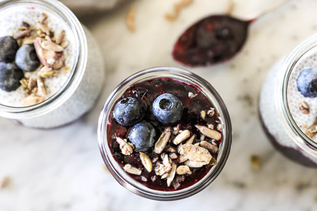 Paleo chia seed pudding horizontal overhead shot with 3 jars and spoon