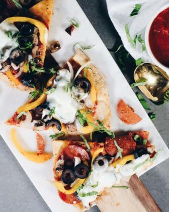 Slices of paleo pizza on a marble cutting board