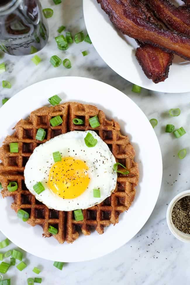 Savory Paleo waffles topped with a fried egg and green onion.