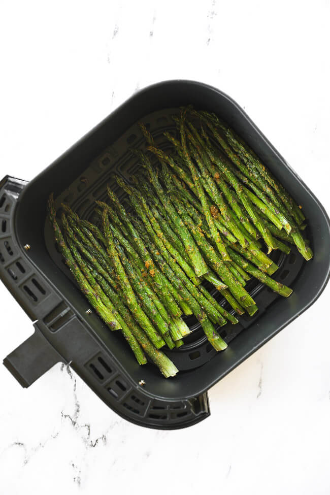 Asparagus after cooking in the air fryer basket. 
