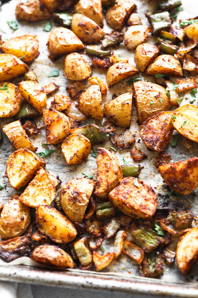 Roasted mexican potatoes on a sheet pan close up angle image