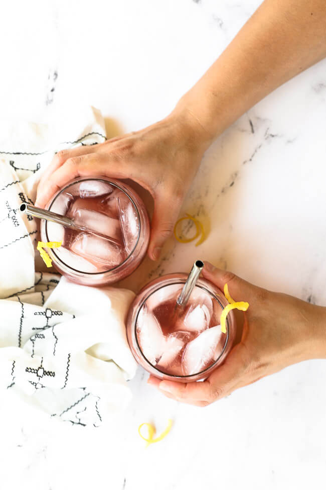 Overhead image of holding two glasses of this vodka lemonade cocktail. 