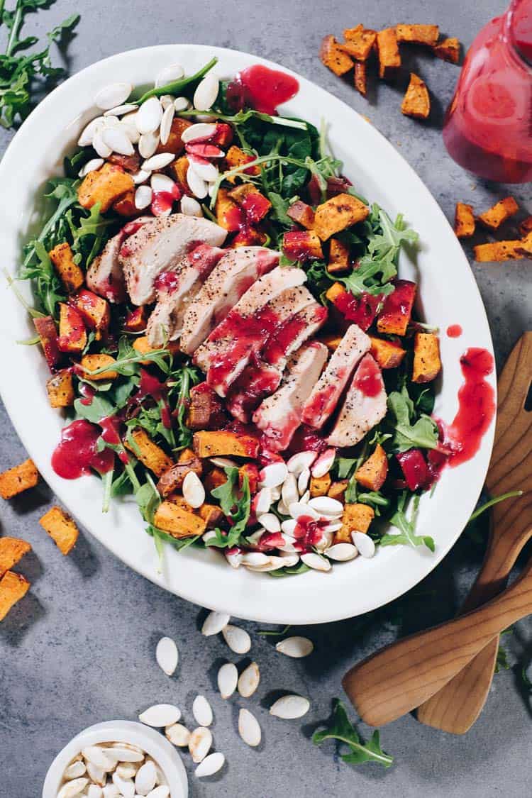 Looking for a new, festive dish to add to your holiday celebrations this year? Try this Paleo Roasted Sweet Potato Salad with Cranberry Vinaigrette! | realsimplegood.com