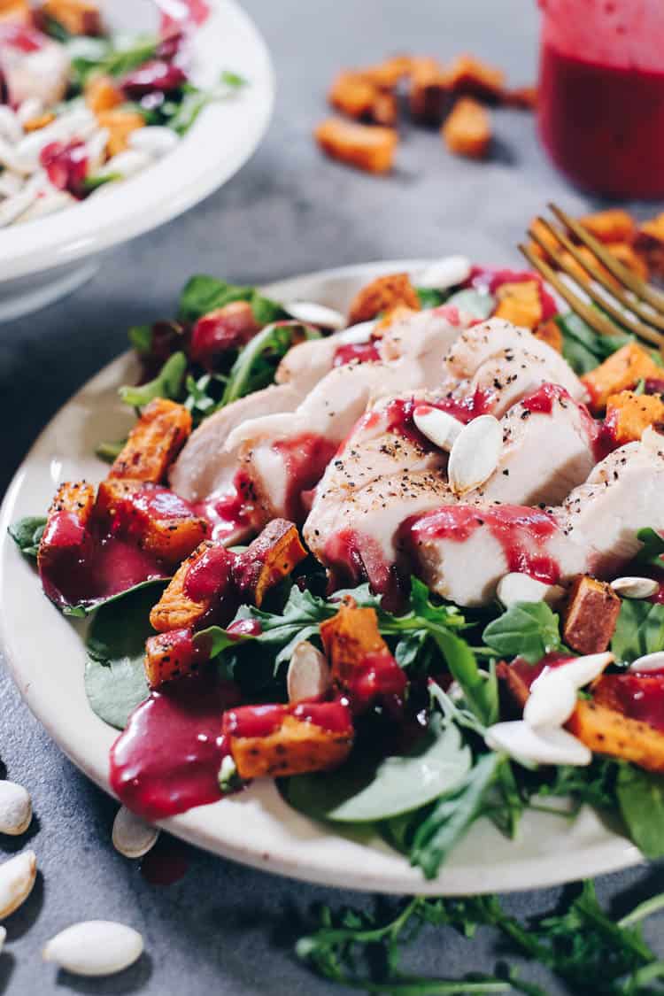 Looking for a new, festive dish to add to your holiday celebrations this year? Try this Paleo Roasted Sweet Potato Salad with Cranberry Vinaigrette! | realsimplegood.com