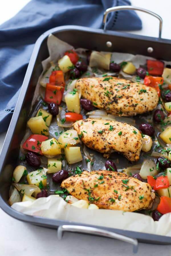 Mediterranean roast chicken in a pan with veggies