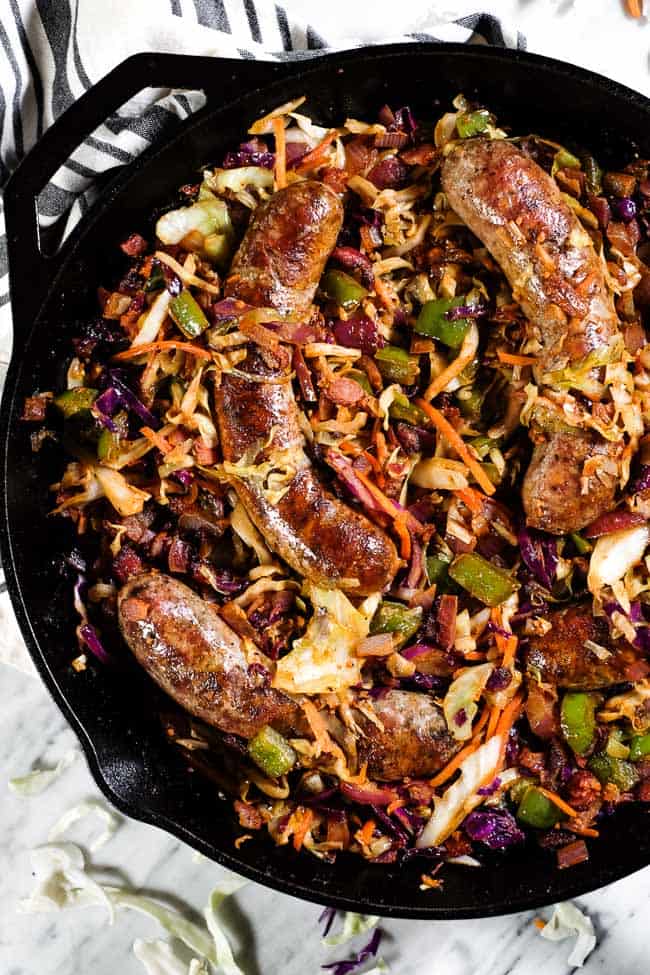 Sausage and cabbage skillet in a large cast iron skillet. 