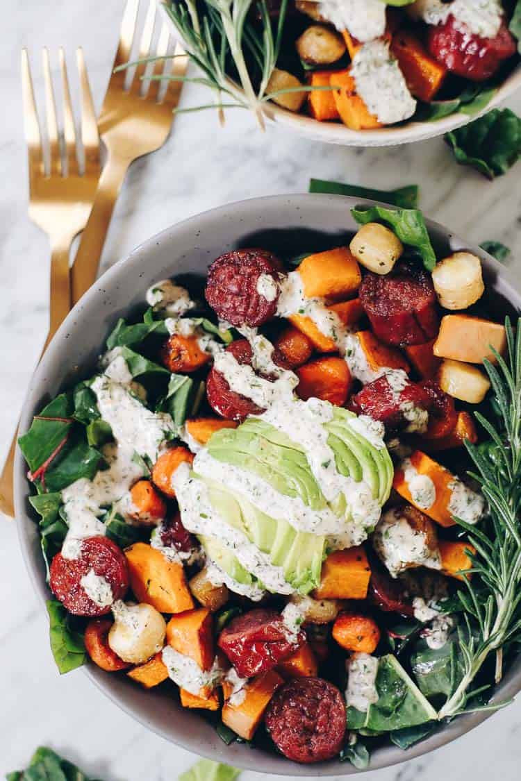 Whether you have an egg allergy or just want to mix things up, this Paleo and Whole30 Sheet Pan Roasted Sausage and Vegetables dish is for you! Squash, parsnips, carrots, sausage, greens and a creamy ranch. Paleo + Whole30 | realsimplegood.com