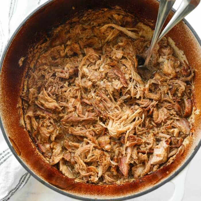 Overhead shot of dutch oven pulled pork shredded.