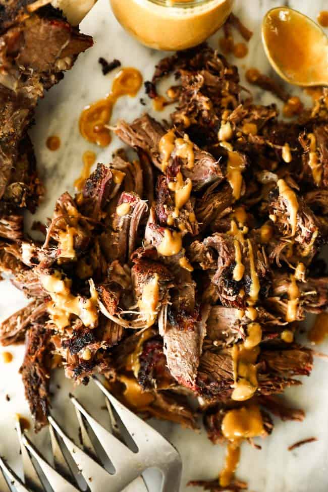 Pulled smoked chuck roast vertical image with mustard sauce over top 