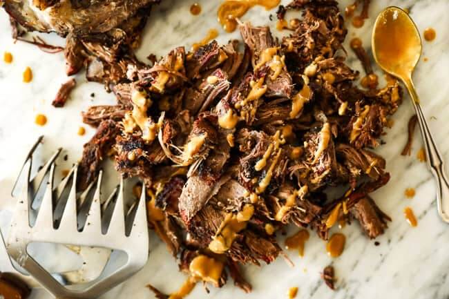 Pulled smoked chuck roast horizontal image with mustard sauce over top 