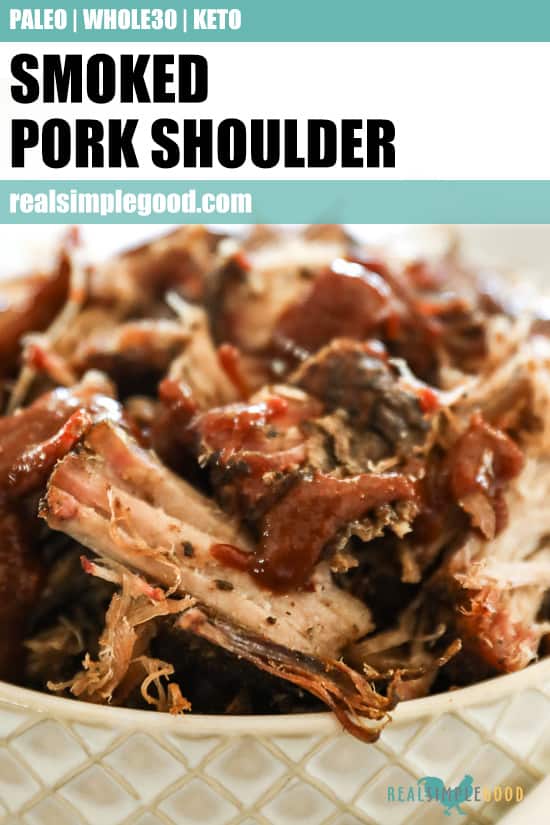 Close up image of smoked pork shoulder in a bowl with bbq drizzled on top. Text overlay at top of image for pinterest. 