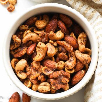 Overhead shot of ramekin full of homemade spicy nuts including walnuts, almonds, cashews and hazelnuts