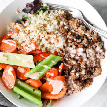 Spicy ground pork bowls with veggies and sauce over the top