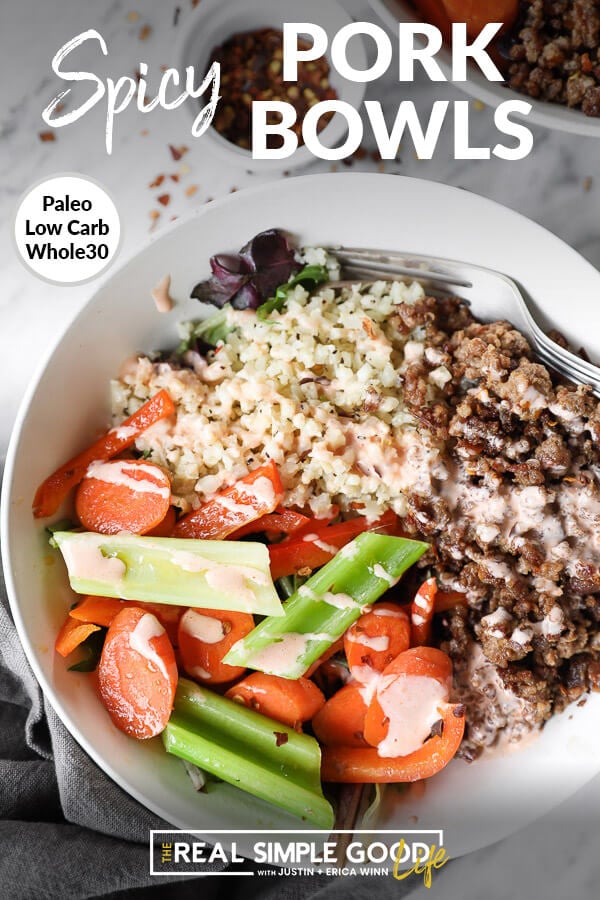 Vertical close up image of bowl of cauliflower rice, spicy pork and veggies with text overlay at top that says "Spicy Pork Bowls - Paleo, Whole30, Low Carb". 