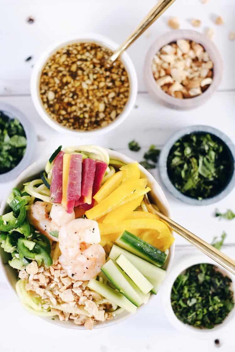 This shrimp zoodle spring roll bowl is packed with fresh and vibrant flavors and colors! It's light and refreshing, yet satisfying at the same time! Paleo, Whole30, Gluten-Free, Soy-Free + Dairy-Free. | realsimplegood.com