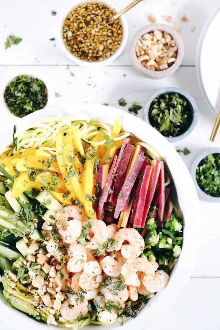 This shrimp zoodle spring roll bowl is packed with fresh and vibrant flavors and colors! It's light and refreshing, yet satisfying at the same time! Paleo, Whole30, Gluten-Free, Soy-Free + Dairy-Free. | realsimplegood.com