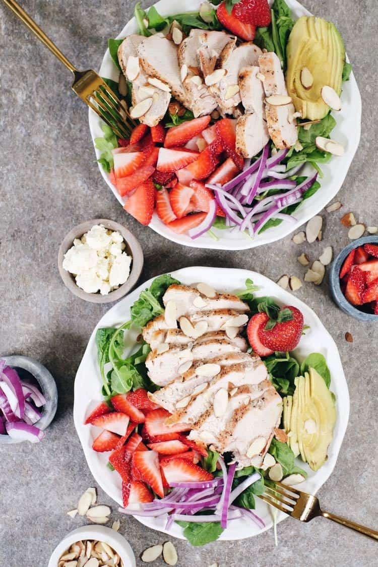 In just 30 minutes this Paleo + Whole30 savory and sweet strawberry chicken salad will be on the table! It's full of flavor and super easy to make! Simple chicken pairs perfectly with arugula, spinach, strawberries, avocado, red onion, sliced almonds and an easy balsamic dressing. Paleo + Whole30 | realsimplegood.com