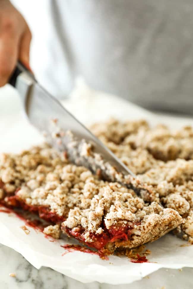 Image of cutting strawberry crumble bars. 