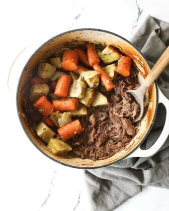 Overhead image of dutch oven pot roast with carrots and potatoes