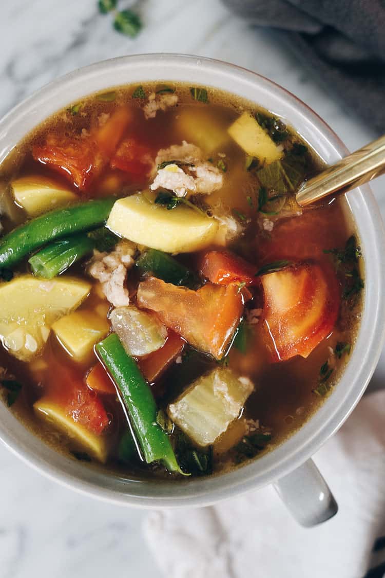 The abundance of summer produce inspired this Paleo and Whole30 turkey and summer vegetable soup. It's the perfect way to use up your garden fresh veggies! Filled with onion, celery, garlic, herbs, tomatoes and summer squash. Paleo + Whole30 | realsimplegood.com