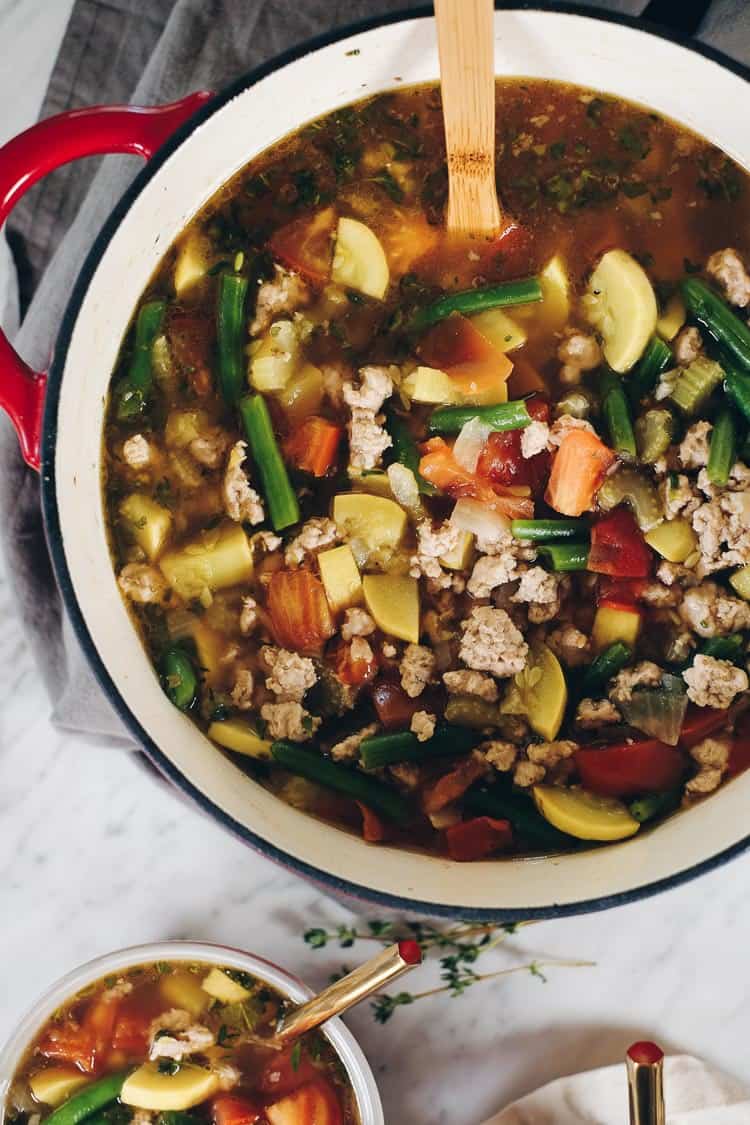 The abundance of summer produce inspired this Paleo and Whole30 turkey and summer vegetable soup. It's the perfect way to use up your garden fresh veggies! Filled with onion, celery, garlic, herbs, tomatoes and summer squash. Paleo + Whole30 | realsimplegood.com