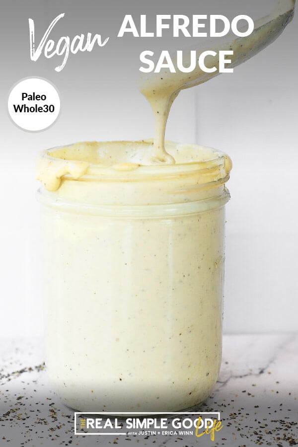 Vertical close up image of vegan alfredo sauce in a mason jar with a spoonful being pulled out. Text overlay at top of image. 