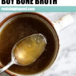 A blog post about where to buy bone broth and why you should add it to your diet. Mug of bone broth with a spoon to show gelatin content.