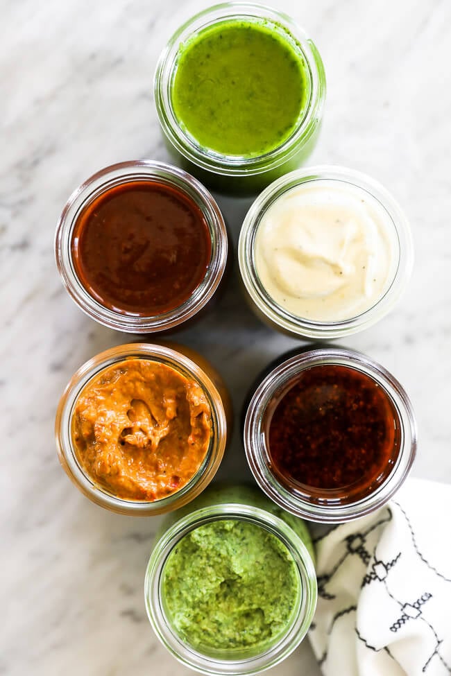 6 easy whole30 sauces in jars overhead shot vertical image