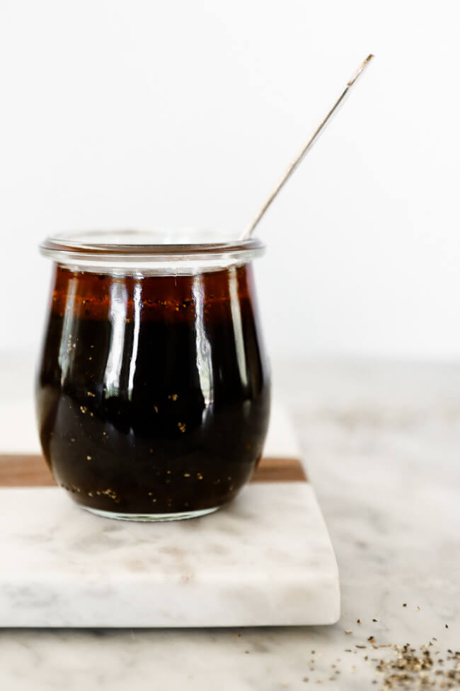 Whole30 stir-fry sauce in jar with spoon coming out straight on shot