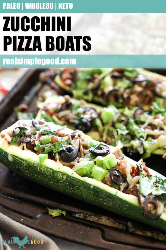 Angled vertical image of zucchini pizza boats on sheet pan with text at top. Loaded with marinara sauce, italian sausage, bell pepper, mushrooms, olives and cheese. Fresh basil sprinkled on top. 