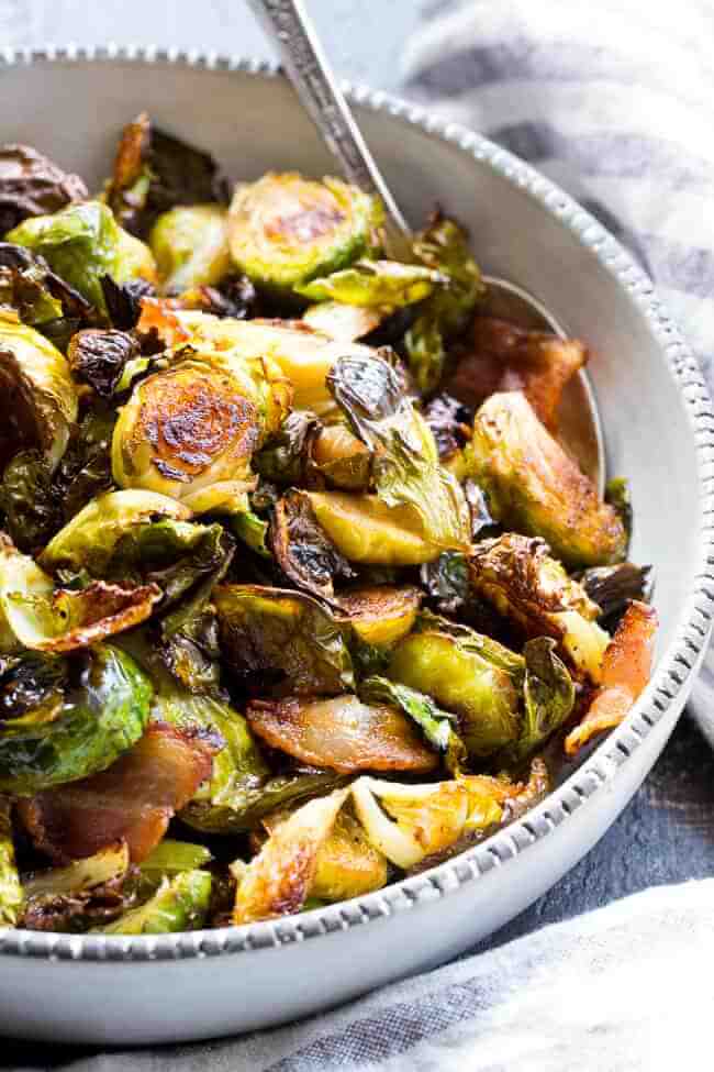 Angle image of roasted brussels sprouts in a bowl with spoon